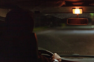 a man driving a car at night